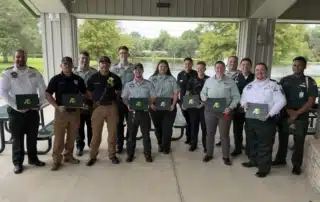 A group of first responders smiles with their Meritorious Service Awards.