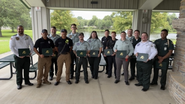A group of first responders smiles with their Meritorious Service Awards.