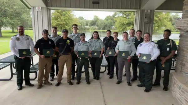 A group of first responders smiles with their Meritorious Service Awards.