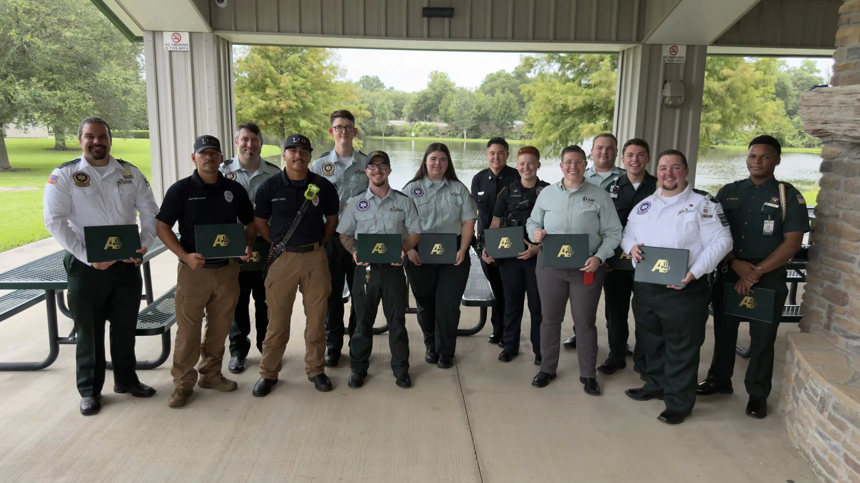 A group of first responders smiles with their Meritorious Service Awards.