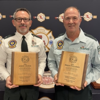 Jimmy Dupuy and Brent Pellegrin holding their EMS Hall of Fame plaques.
