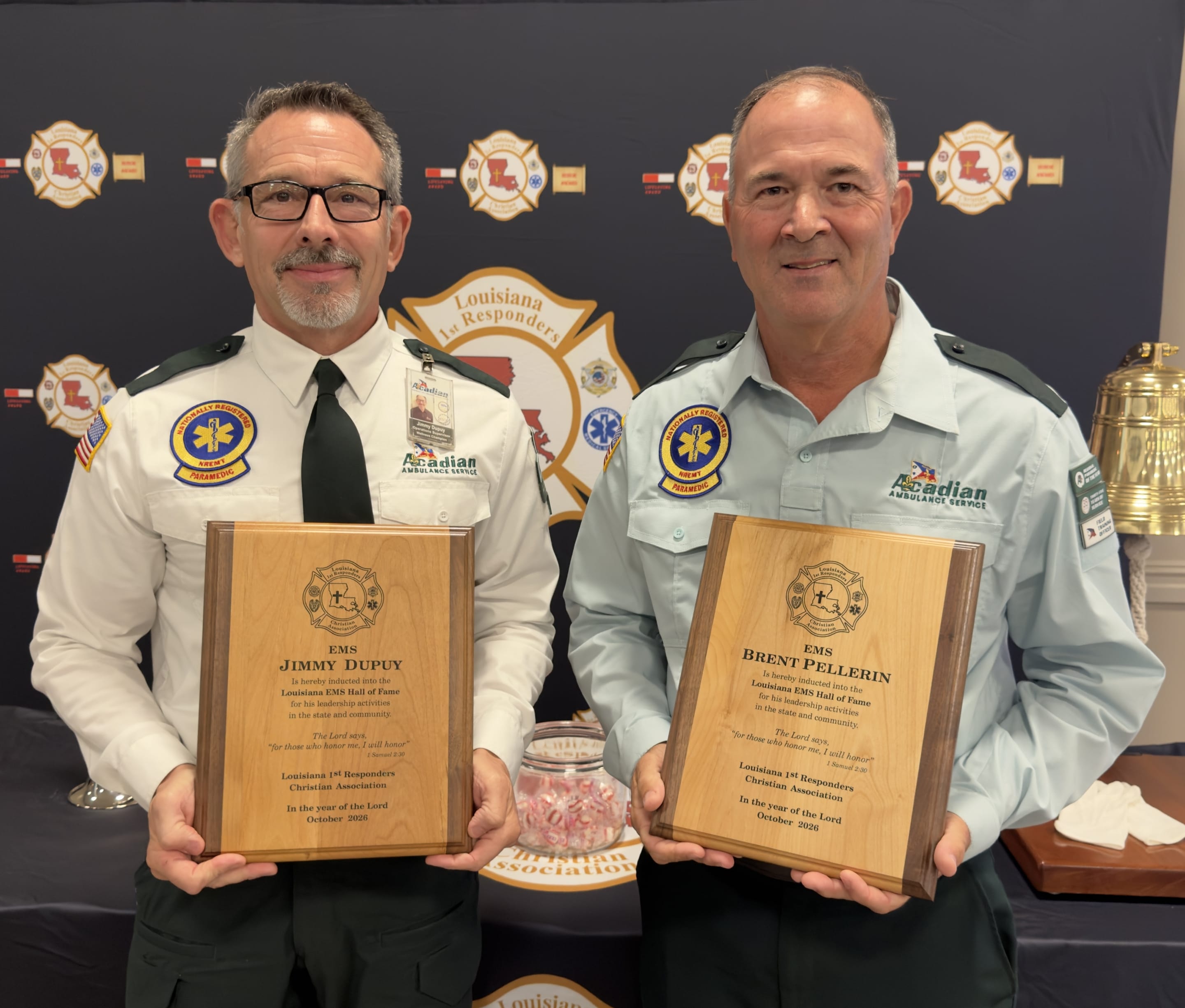 Jimmy Dupuy and Brent Pellegrin holding their EMS Hall of Fame plaques.