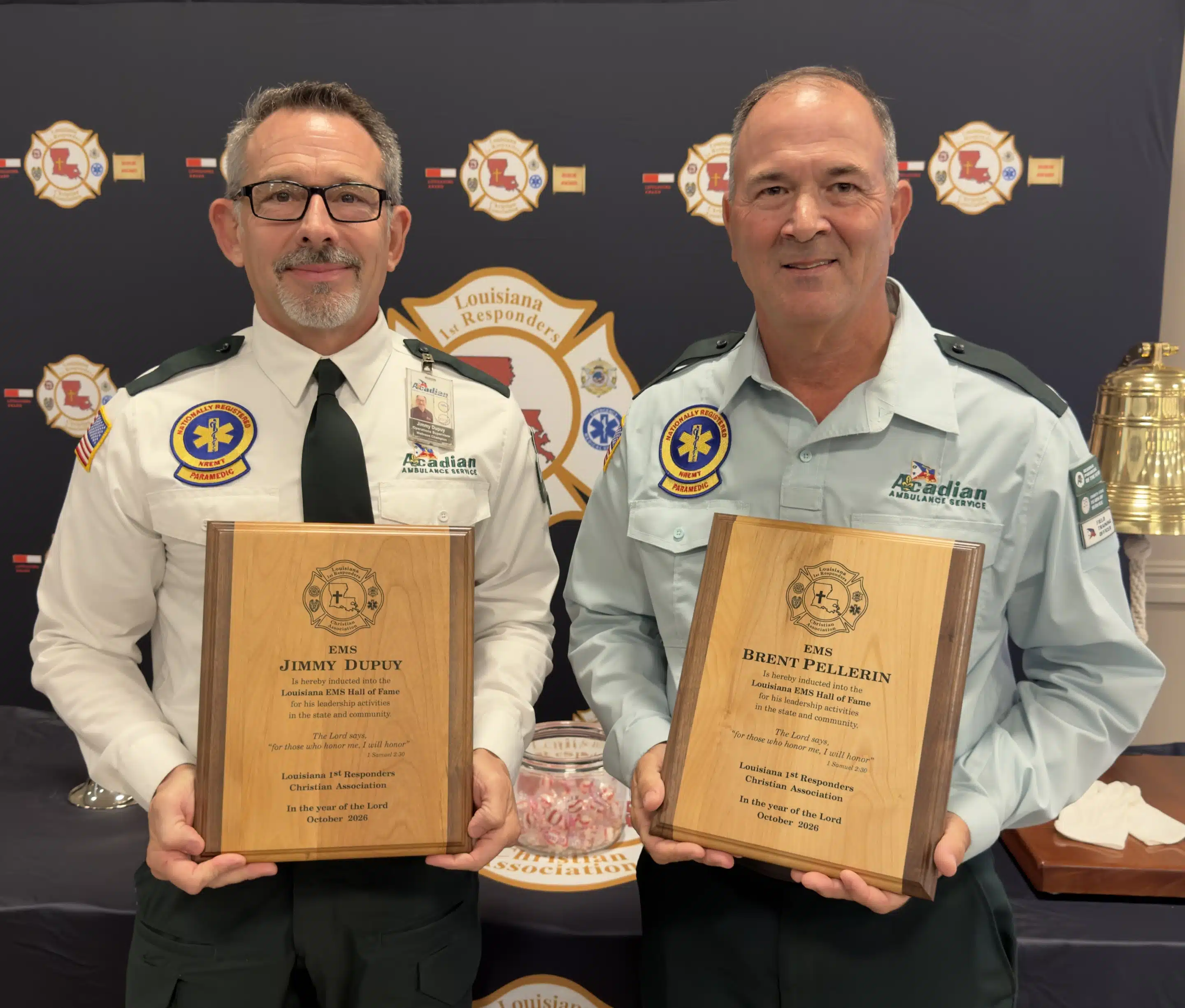 Jimmy Dupuy and Brent Pellegrin holding their EMS Hall of Fame plaques.