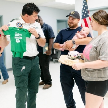 An Acadian Ambulance employee speaks with the family of Stevie Moses.