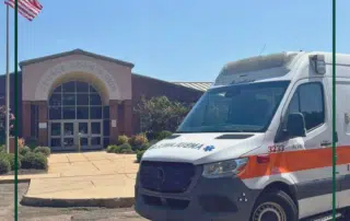 A photo of an Acadian Ambulance in front of George County High School