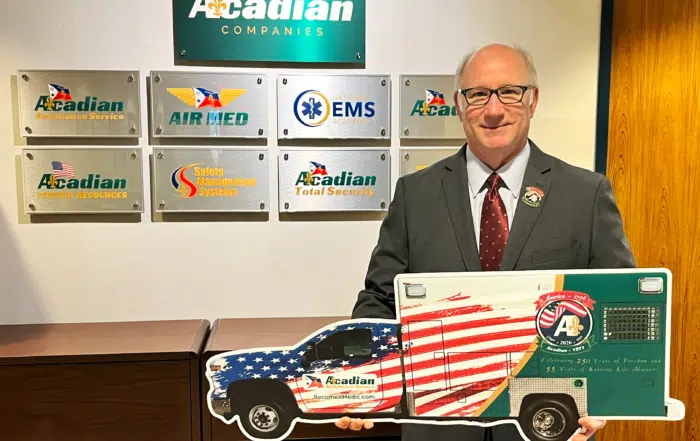 CEO Eddy Dupuis with a cutout of Acadian Ambulance's America 250 unit.