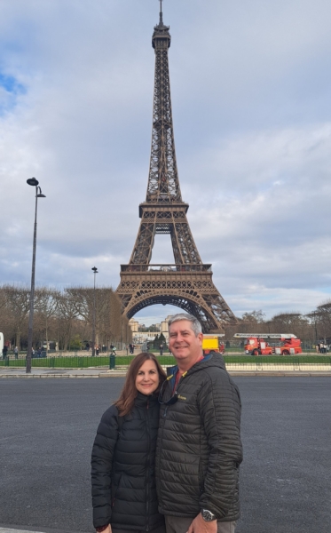 Richard Belle and his wife pose in front of the Eiffel Tower.
