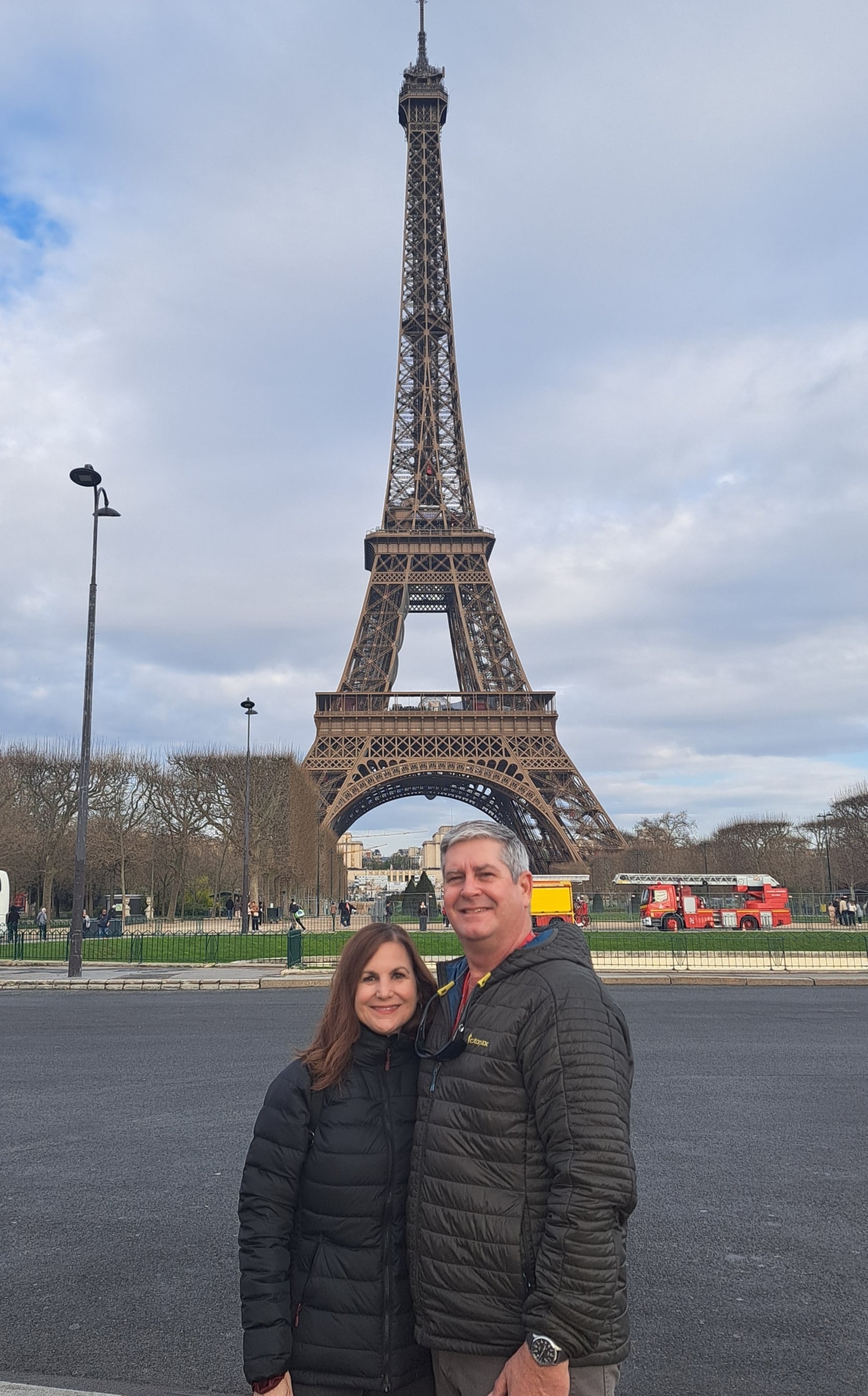 Richard Belle and his wife pose in front of the Eiffel Tower.