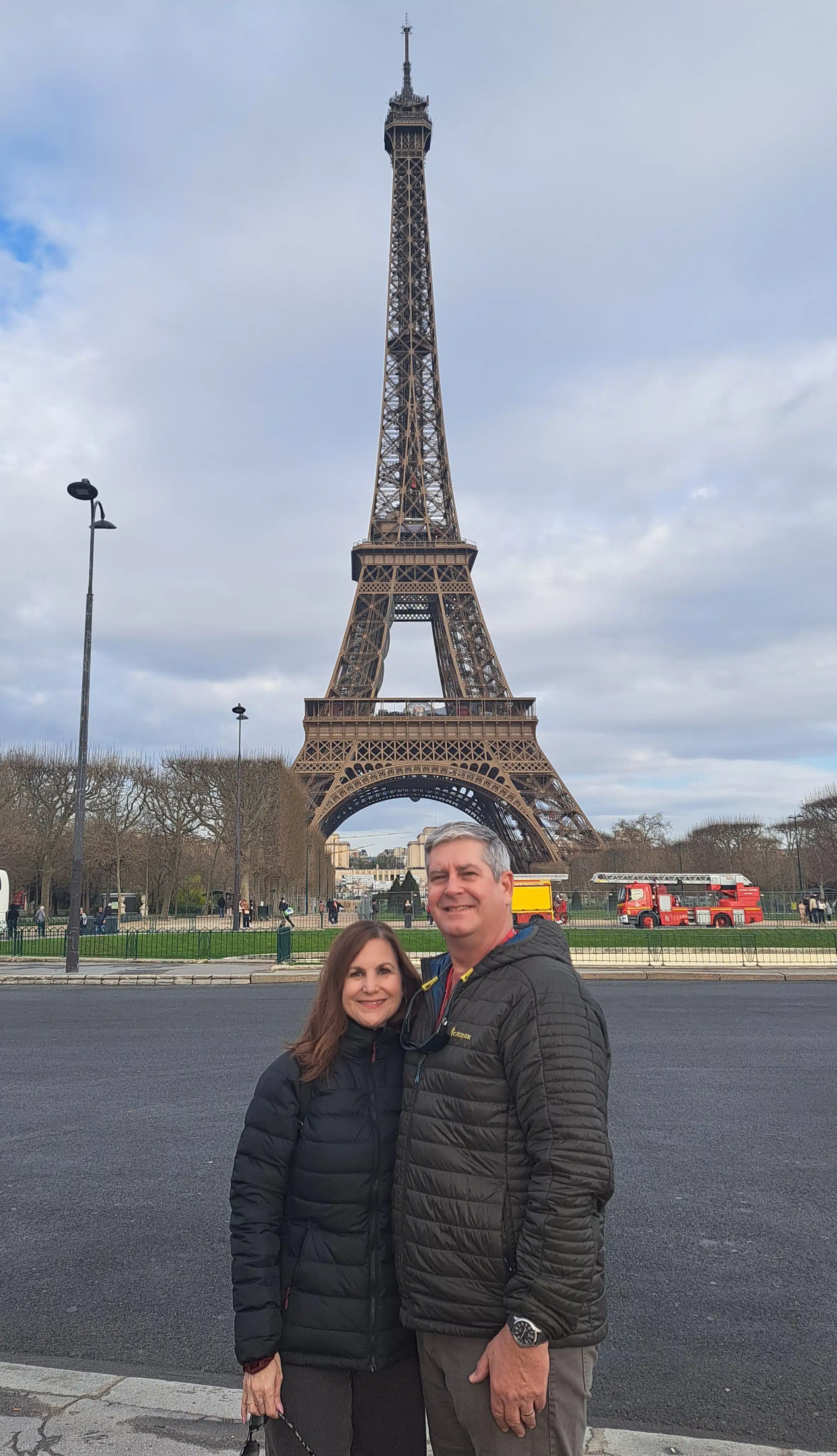 Richard Belle and his wife pose in front of the Eiffel Tower.