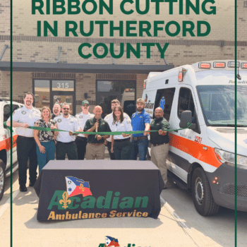 Acadian Ambulance Tennessee team members cut a green ribbon in front of Acadian's new station in Rutherford County.