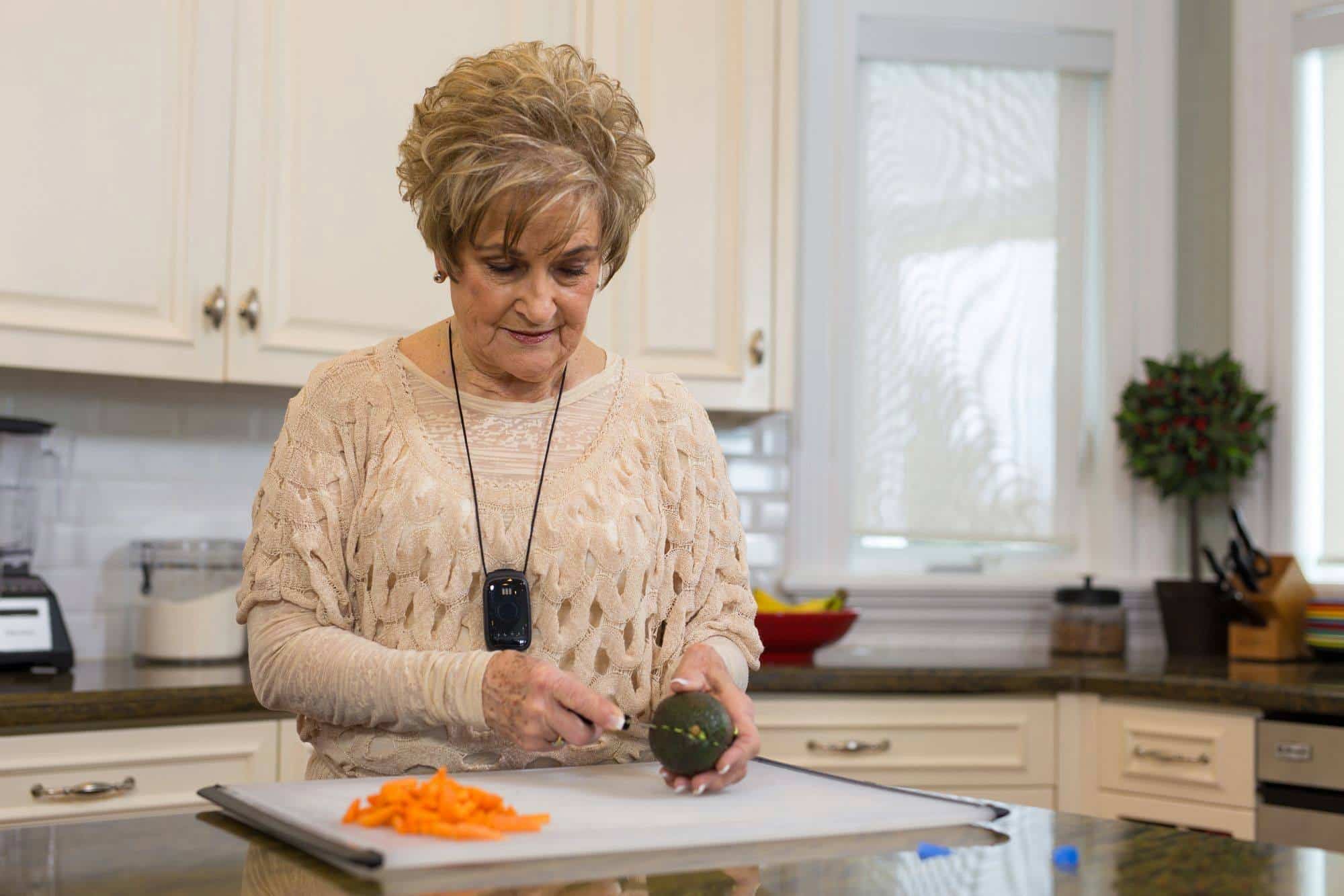 medical-alert-pendant woman in kitchen wearing medical alert pendant
